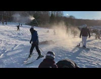 Guy on skis sprays snow on stranger
