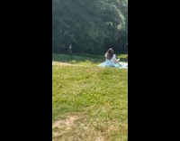 Girl blue gown sit grass downhill tripod