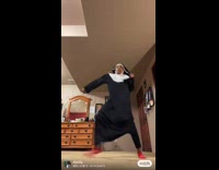 Woman in nun costume dances to classical music 