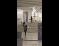 White jacket girl poses stairs purple sign 