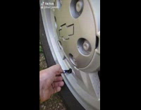 Little boy takes wheel air covers off