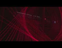 Red laser light beams move around music 