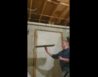 Guy draws spiral on spinning white board 