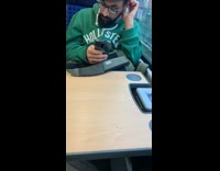 Man in green Hollister jacket scratches head and ear and has dandruff on shoulder