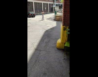 Green shirt guy crosses arms parking lot 