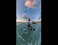 Guy goes kitesurfing while drone follows 