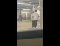 Guy poses with concrete column parking garage