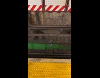 Green liquid puddle on subway train tracks
