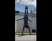 Guy grey shirt do handstand on gutter