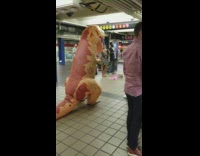 Trex dinosaur blow up costume enjoying opera subway 