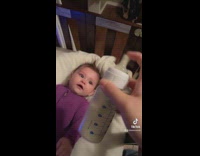 Baby in crib excited for milk screams 