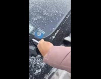 Girl uses black spatula to scrape ice 