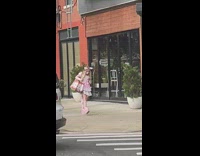 Girl in all pink outfit walking on street