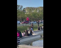Woman poses with heart balloons at the park