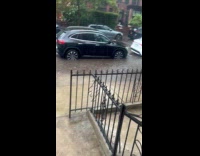 Woman shows flood water flow on street