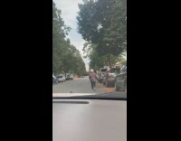 Woman running on side of street to her car in red flannel