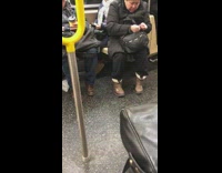 Guy brown boots clips nails on subway train