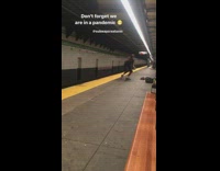 Guy spins around spraying disinfectant subway platform 