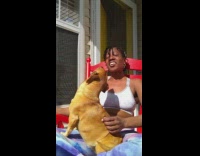 Woman sit on chair with dog sunbath