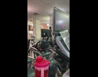 Blue shirt guy dances while exercising stairmaster  