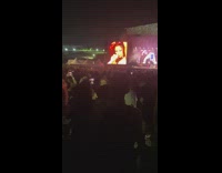Woman dances around the crowd of a concert