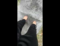 Guy walking outside on ice barefoot slides down driveway 