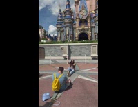 Girl sit middle of star Disneyland castle
