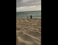 Woman white sweater hat raise feet beach