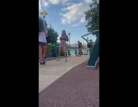 Woman with a fanny pack tiktok dance at the park