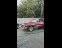 Guy in red car with halloween werewolf decoration 