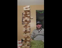 Jenga tower falls after woman pulls out