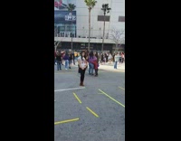 Woman takes pictures at Kobe Bryant memorial