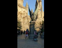 Woman in white tank top raises foot at the Harry Potter Castle