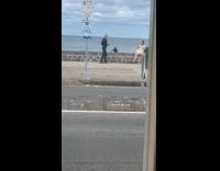 Collab IITW - Woman white dress poses  by the beach