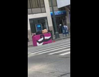 Guy takes nap on pink traffic barrier 