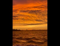 Orange horizon sunset captured from ferry ride