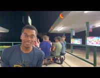 Guy shows cup behind himself 