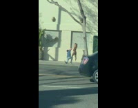 Man Kneels as Lady Poses for Pictures