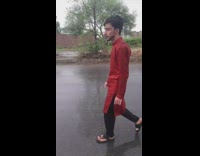 Guy wears red kurta walks down street