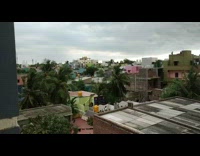 Houses under grey storm clouds Chennai India