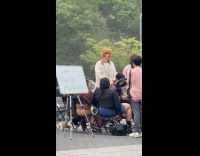 Crowd watching man give creepy public massage 