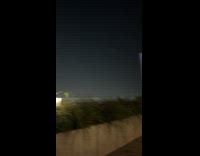 Woman raises hands for hold moon pose