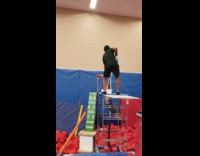 Guy practices spin on bar falls off