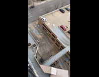 Man black tank top parkour climb down parking lot