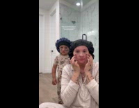 Toddler copies mom doing skin care