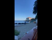 Man in jumper selfie run at beach