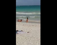 Topless woman kneel side pose beach stick