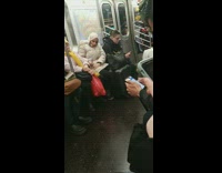 Guy has elf ears on subway train