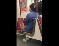 Woman blue jacket barefoot on train seats