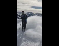 Blue yellow jacket skier crashes into friend